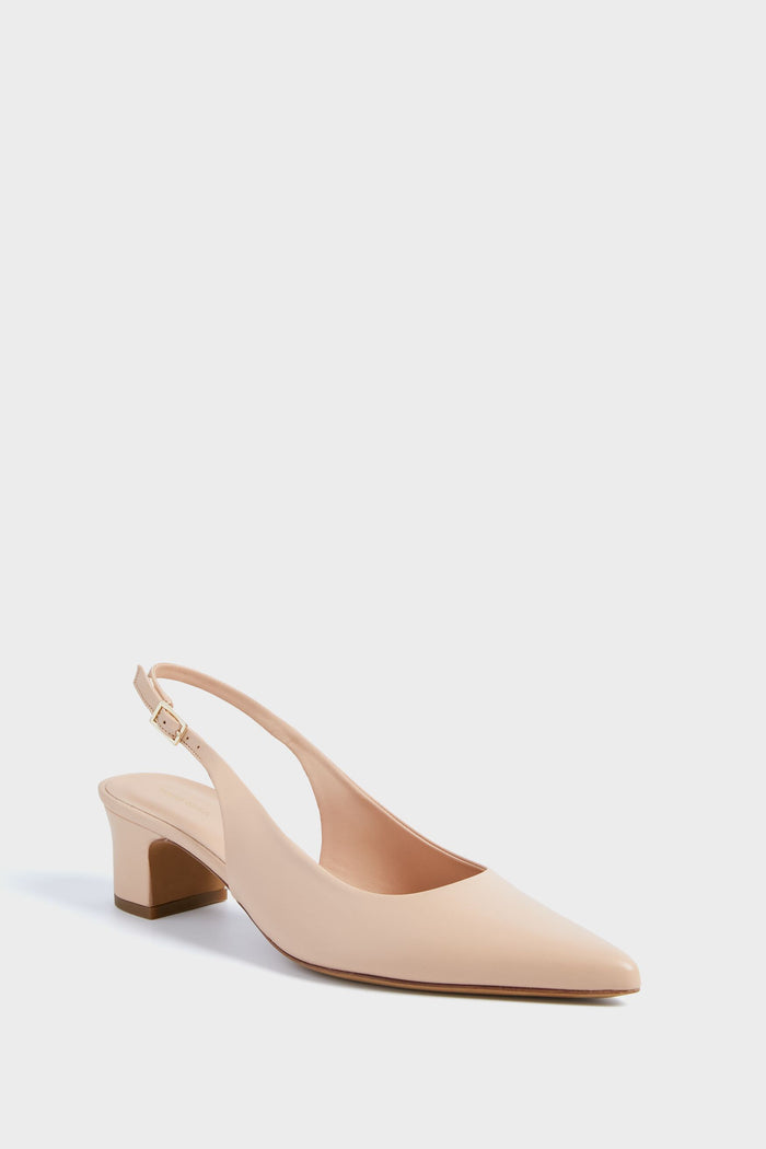 A nude leather slingback by Mansur Gavriel featuring a pointed toe, low block heel, and adjustable strap.