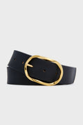 A black Italian cowhide leather belt by B-Low the Belt, elegantly coiled and adorned with a large oval gold buckle.
