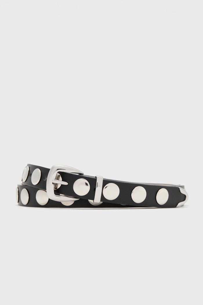 The Petit Moments black studded belt features large silver studs and a sleek silver buckle, making it a stylish and adjustable waist accessory for women's fashion.