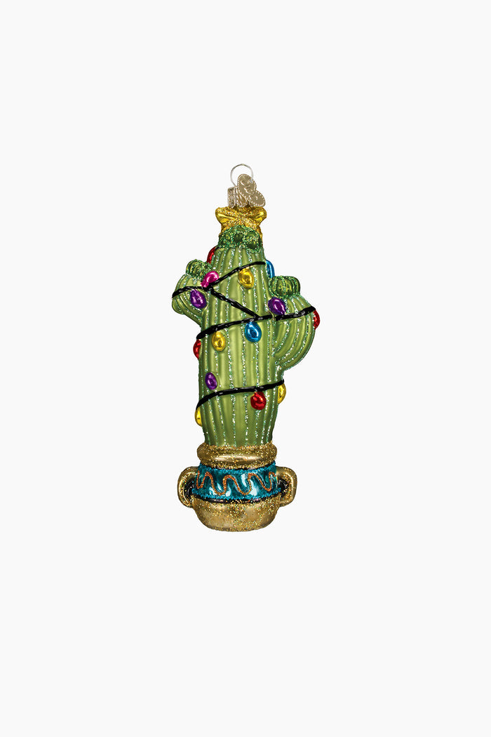 The Old World Christmas hand-painted glass cactus ornament, accented with colorful lights and gold details, hangs from a clear loop.