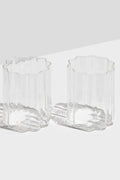 Two FAZEEK scalloped-edged rippled glasses sit side by side on a white surface, elegantly displaying their signature wave design.