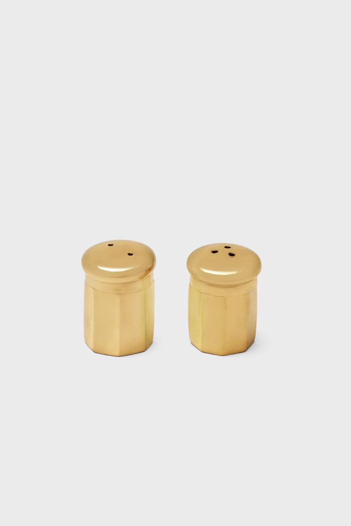 Two Blue Pheasant gold finish salt and pepper shakers with rounded tops and faceted sides are placed side by side, highlighting their elegant brass design.