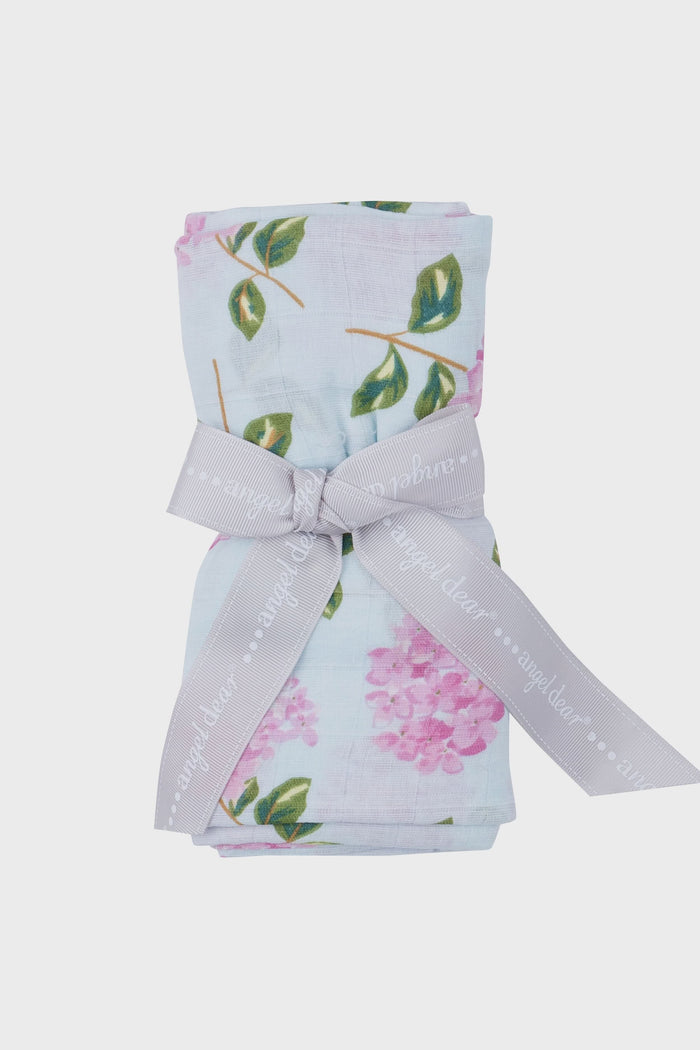 A rolled-up, floral hydrangeas baby blanket by Angel Dear is tied with a gray ribbon—an ideal organic cotton swaddle and perfect baby gift.