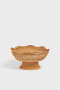 The Tuckernuck Home woven bowl features a wide, flared base and scalloped rim, inspired by classic rattan footed bowls—ideal as a decorative accent for your kitchen.