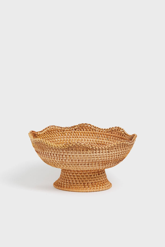 The Tuckernuck Home woven bowl features a wide, flared base and scalloped rim, inspired by classic rattan footed bowls—ideal as a decorative accent for your kitchen.