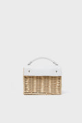 Wicker Wings rectangular woven wicker bag with a white leather top flap and handle, blending sustainable fashion with artisan craftsmanship.