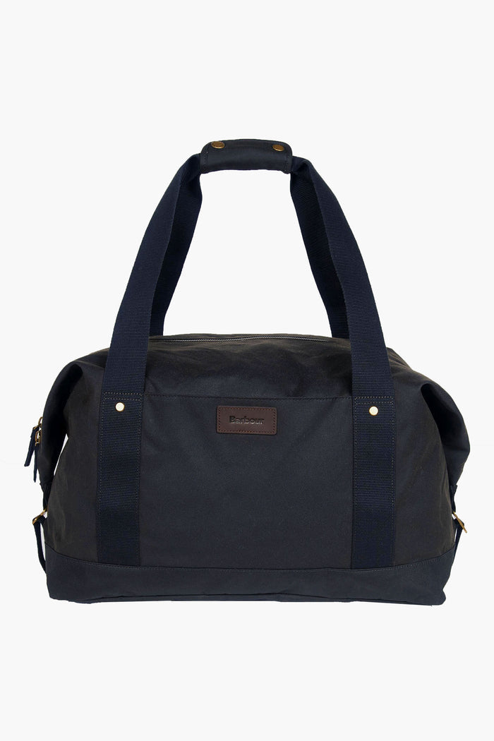 The Barbour black waxed cotton holdall features two sturdy handles and a small front logo patch, making it ideal as an overnight carry bag.