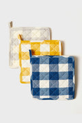 Three Farmhouse Pottery, Inc potholders in gray, yellow, and blue gingham patterns are arranged in a staggered row, each featuring a charming quilted design.