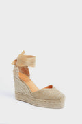 A Castaner espadrille wedge sandal in tan features a closed toe, jute-wrapped sole, and mesh ankle ties.