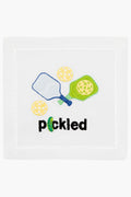 August Morgan white cotton cocktail napkin with embroidered pickleball paddles, balls, and the word "pickled" in black—perfect for your next pickleball-themed gathering.