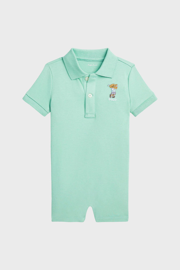 Light green cotton polo romper by Polo Ralph Lauren, featuring a collar, three buttons, and a small embroidered Polo Bear logo on the left chest—an iconic baby clothing piece.