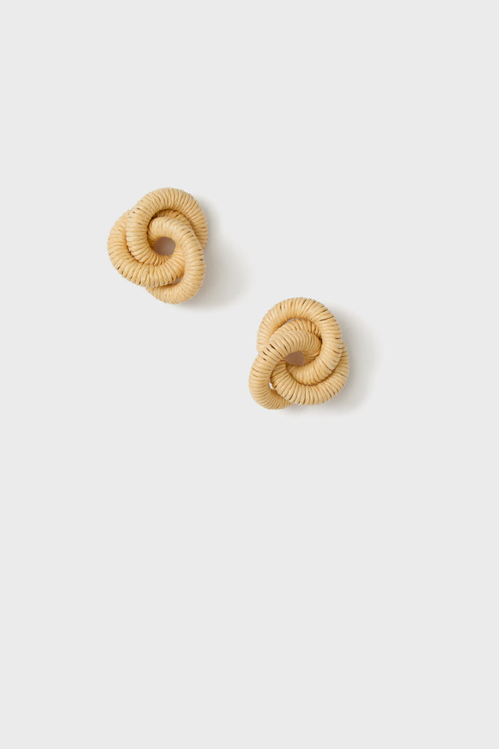 A pair of round, trinity knot earrings crafted from light tan woven raffia.