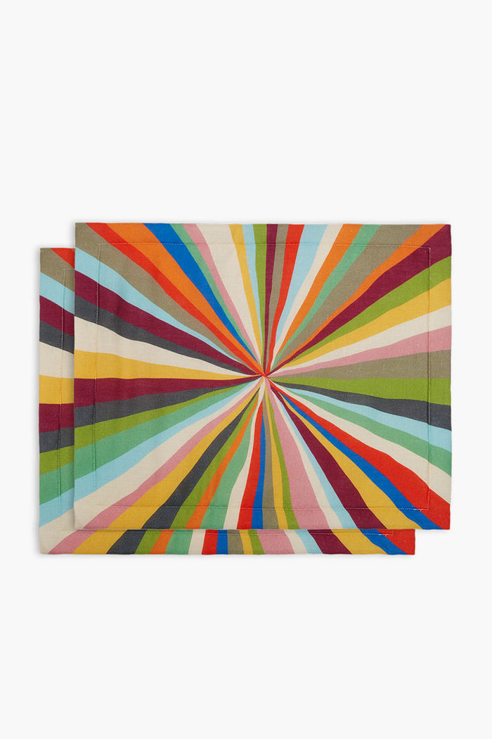 Two rectangular La DoubleJ tablemats featuring a multicolored radial burst pattern with vibrant lines converging at the center.