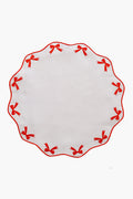 Chefanie round white linen placemat with scalloped edge, red embroidered bows around the border—a charming hostess gift.