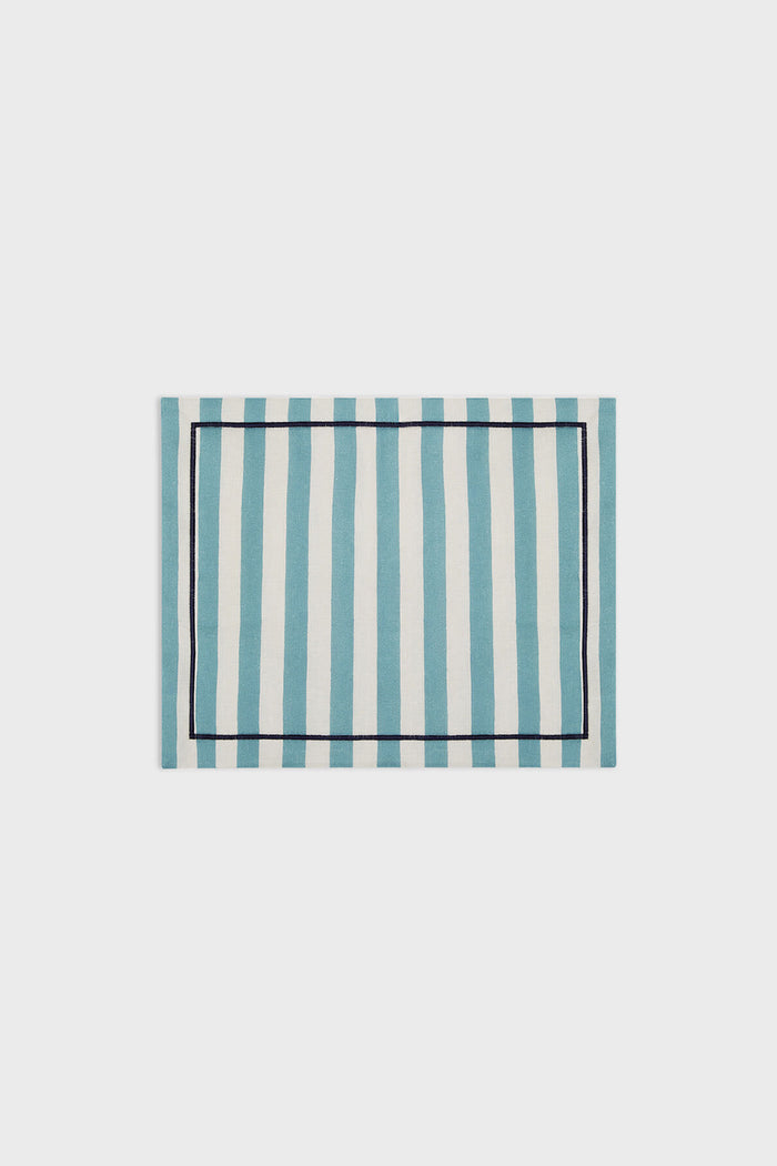 La DoubleJ rectangular linen placemat featuring blue and white vertical stripes with a slim dark border, inspired by classic Italian textile design.