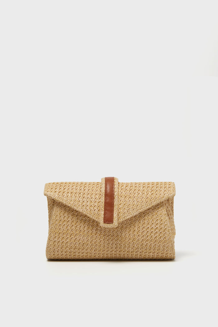 This Tuckernuck Accessories rectangular raffia envelope clutch features a tan leather strap detail on the front, making it a perfect summer accessory.