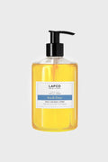 A clear pump bottle of LAFCO New York Sea and Dune Liquid Soap contains yellow liquid and a label noting its plant-based formula.