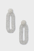 Deepa Gurnani’s silver oval rhinestone statement earrings feature a textured, layered design that captures the allure of handcrafted accessories.