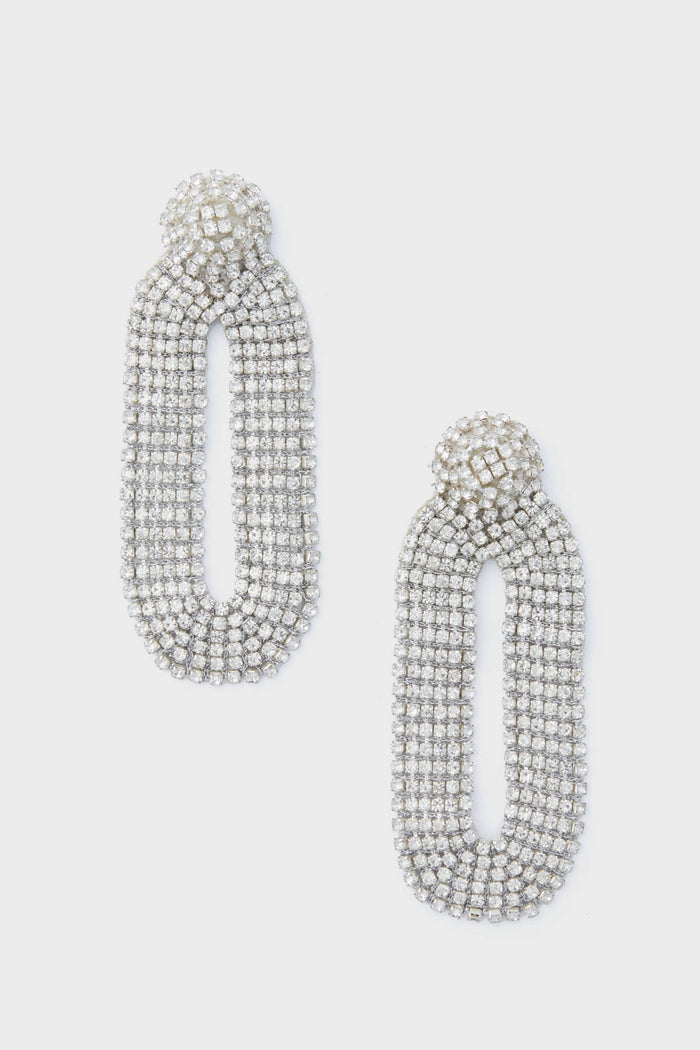 Deepa Gurnani’s silver oval rhinestone statement earrings feature a textured, layered design that captures the allure of handcrafted accessories.