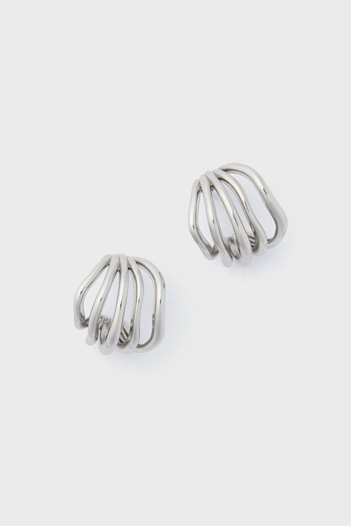 The Petit Moments Silver Sonoma Earrings showcase a sleek silver metal with an open, curved, and layered design—an elevated take on classic hoops.