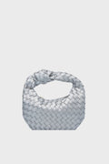 The Urban Expressions silver woven clutch features a knotted handle and an elegant animal-friendly handbag design.