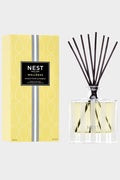 A NEST New York Reed Diffuser in Sunkist Yuzu & Neroli, shown next to its yellow box with a black label, adds a refreshing citrus and floral fragrance to your space.