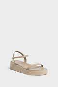 Ancient Greek Sandals beige platform sandal with a thin front strap and small-buckle ankle strap, styled for comfort with a platform sole.