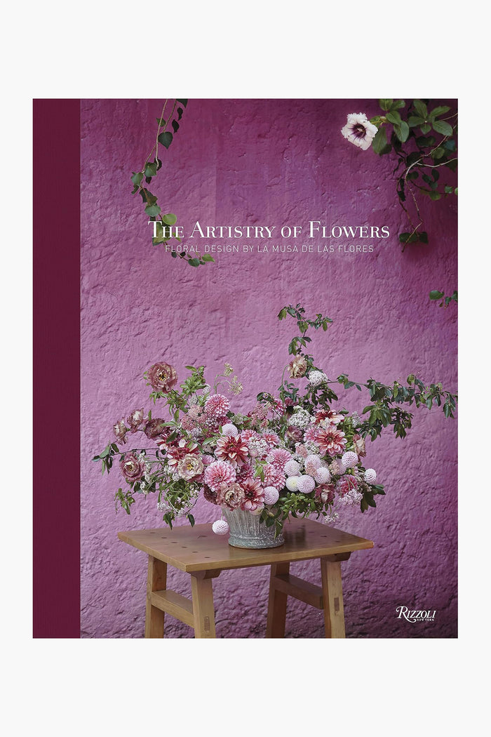 A floral design in a vase sits on a wooden stool, with the text "The Artistry of Flowers" and the brand name Rizzoli displayed at the top of the image.