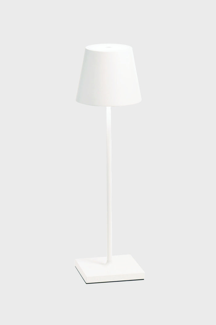 The Zafferano white LED table lamp features a matching shade, cordless illumination, a sleek design, and a rechargeable battery—ideal for any space.